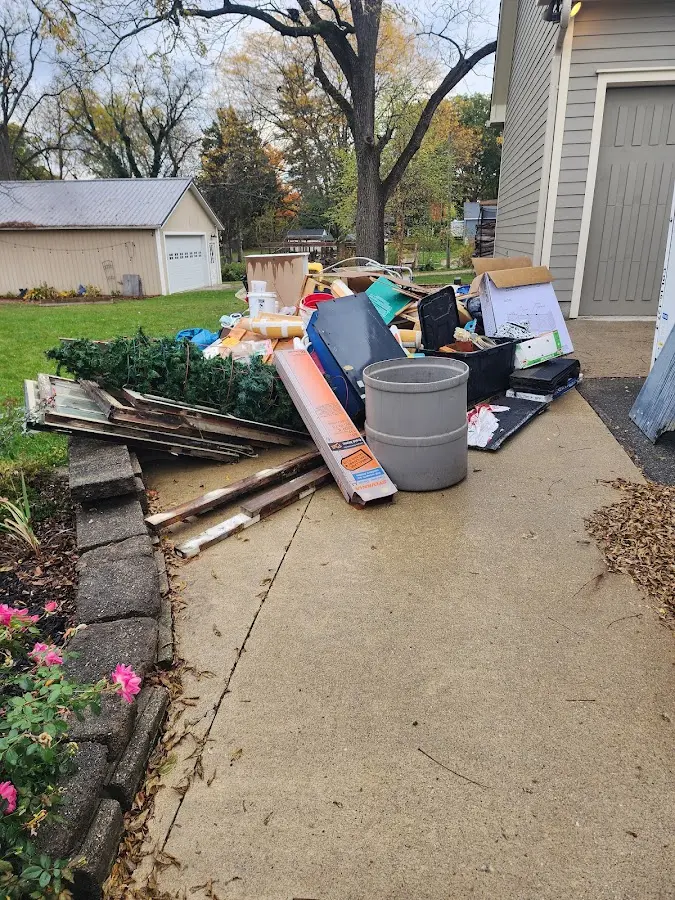 Dumpster being loaded with debris for Estate Cleanout Dumpster Rental in Palmyra